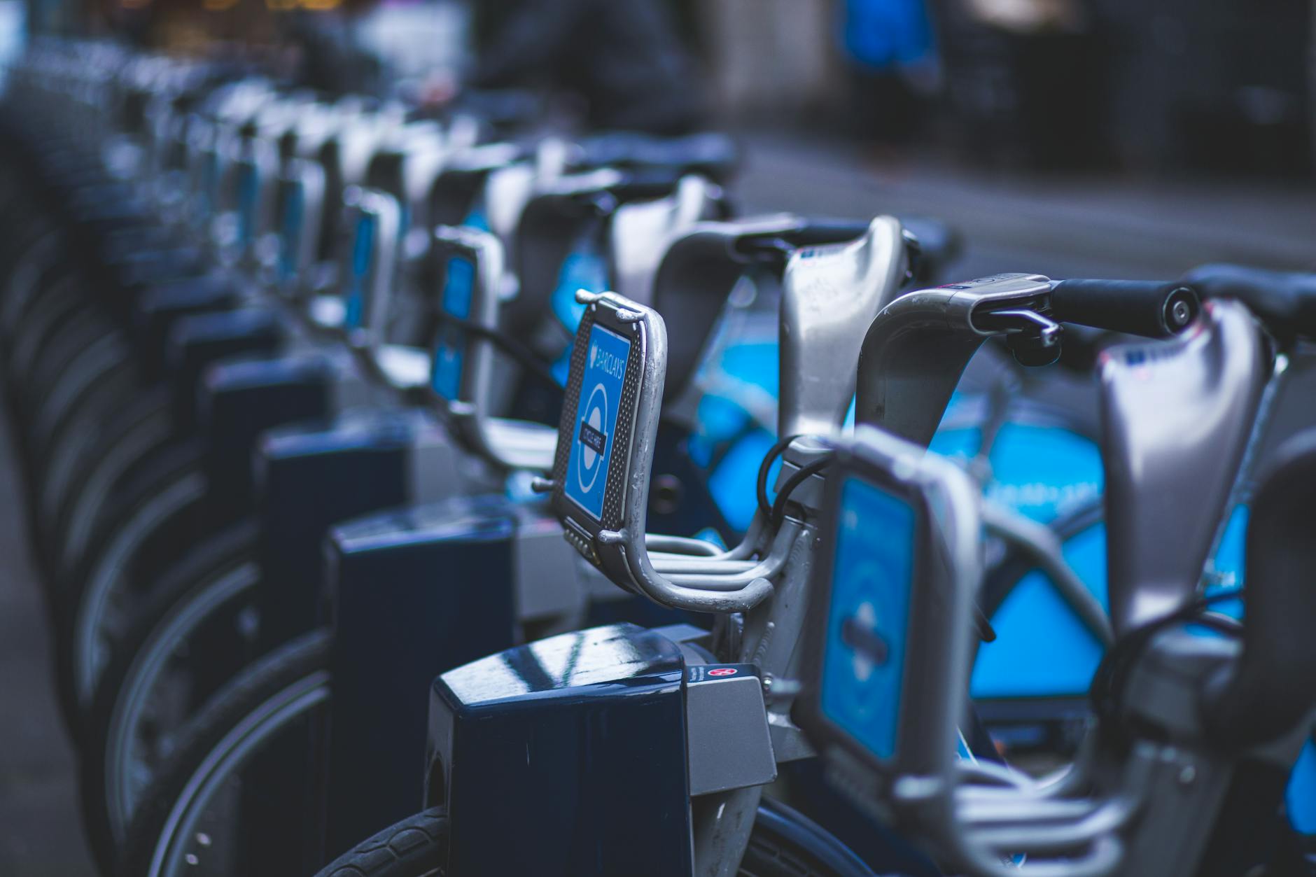 Bike sharing cycling through an urban city street