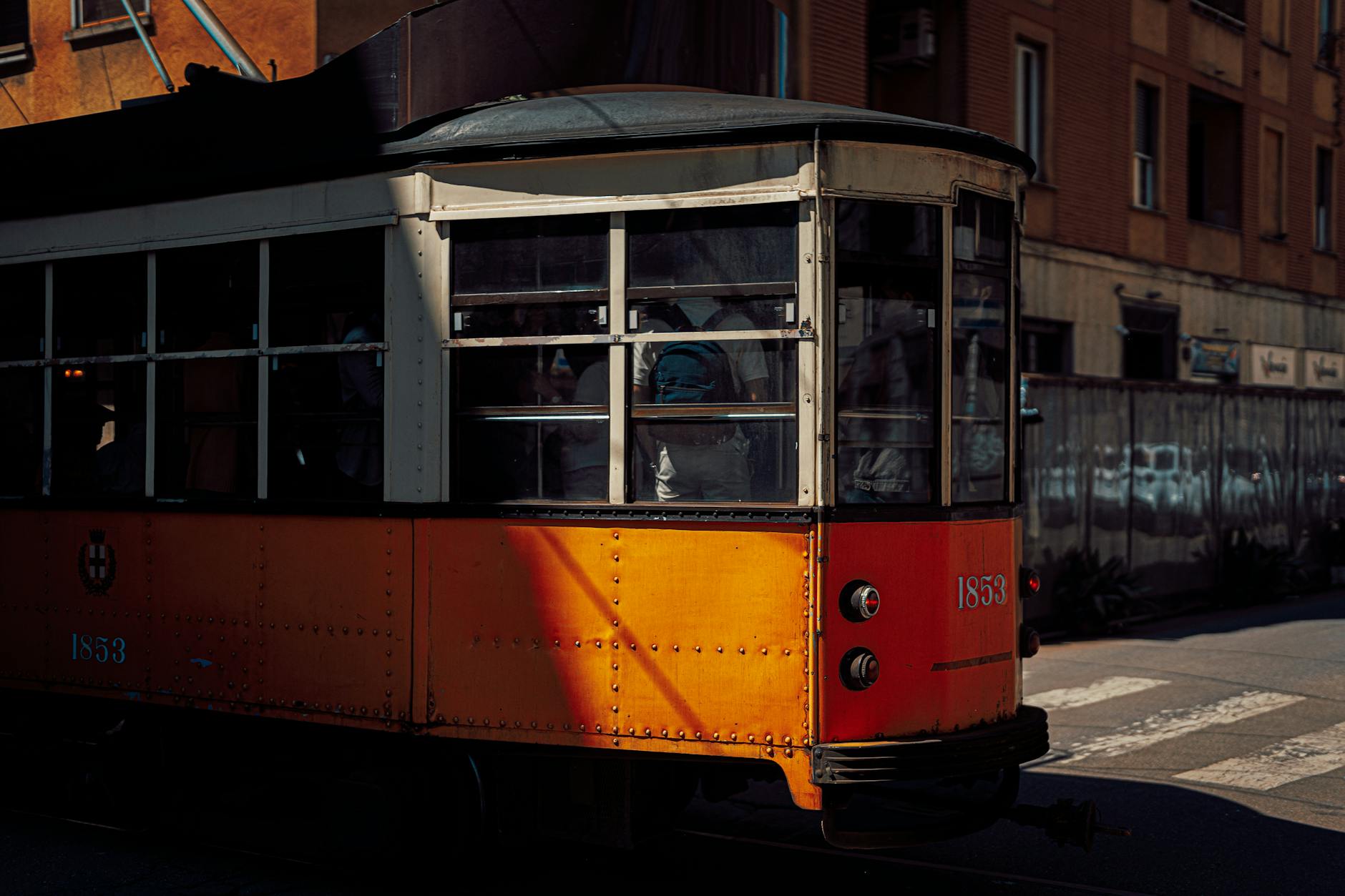 Iconic vintage orange tram on a Milan street