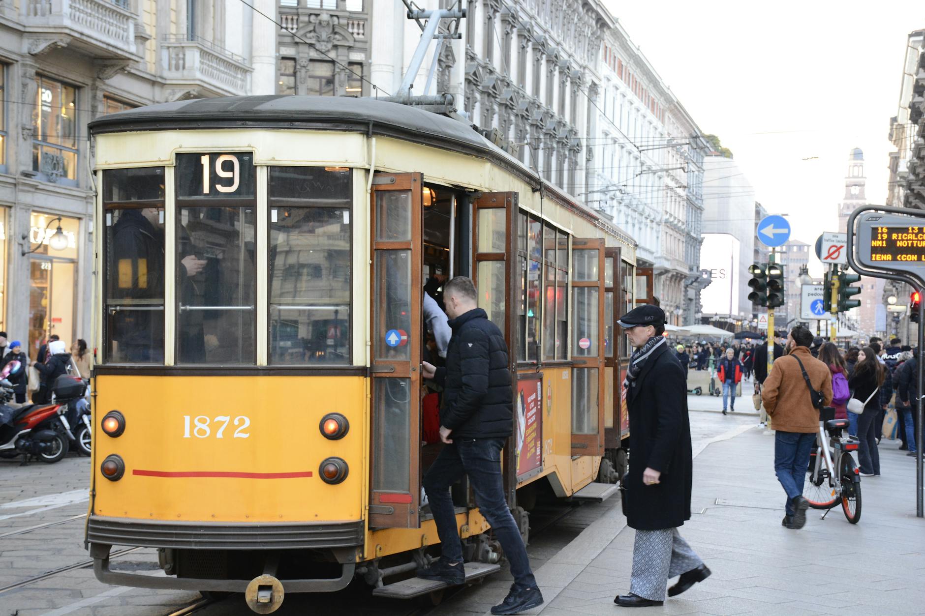 Historic tram on Milan city streets for public transport