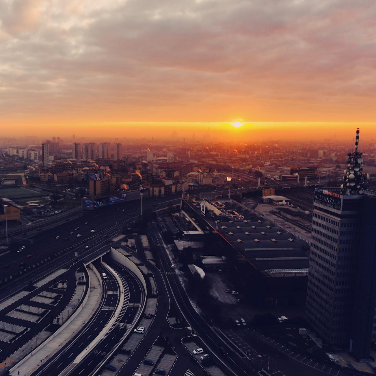 Rooftop bar with Milan skyline view at sunset