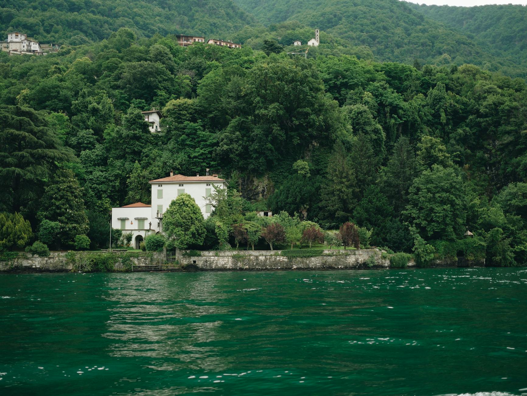 A villa on Lake Como surrounded by lush gardens and greenery