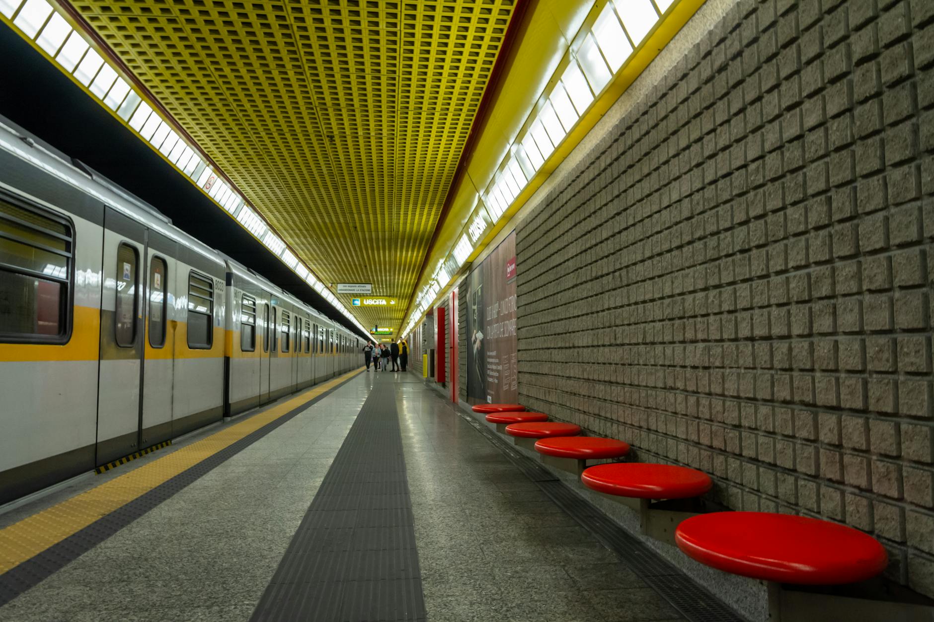 Milan metro station with modern train arriving