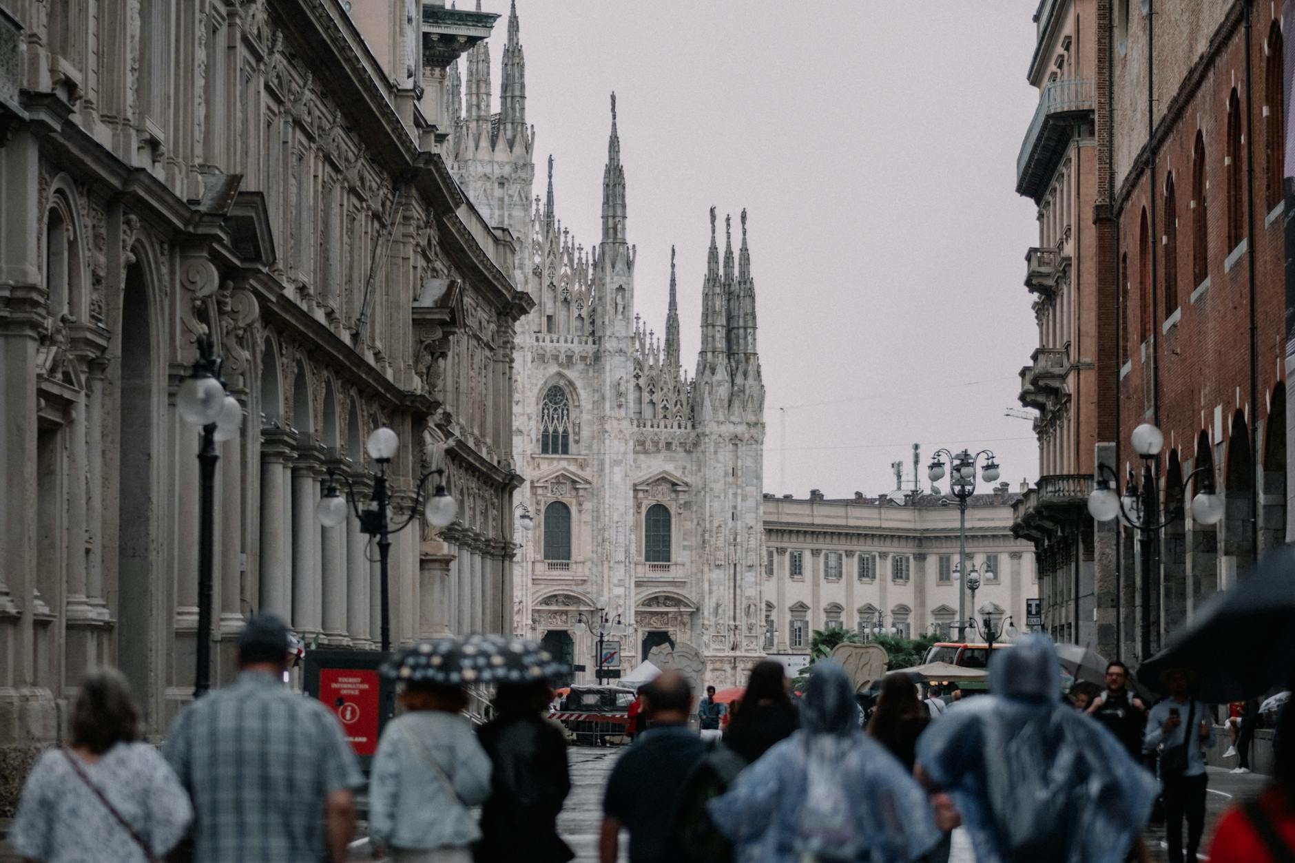 Tourists walking on Milan cobblestone street in historic centre