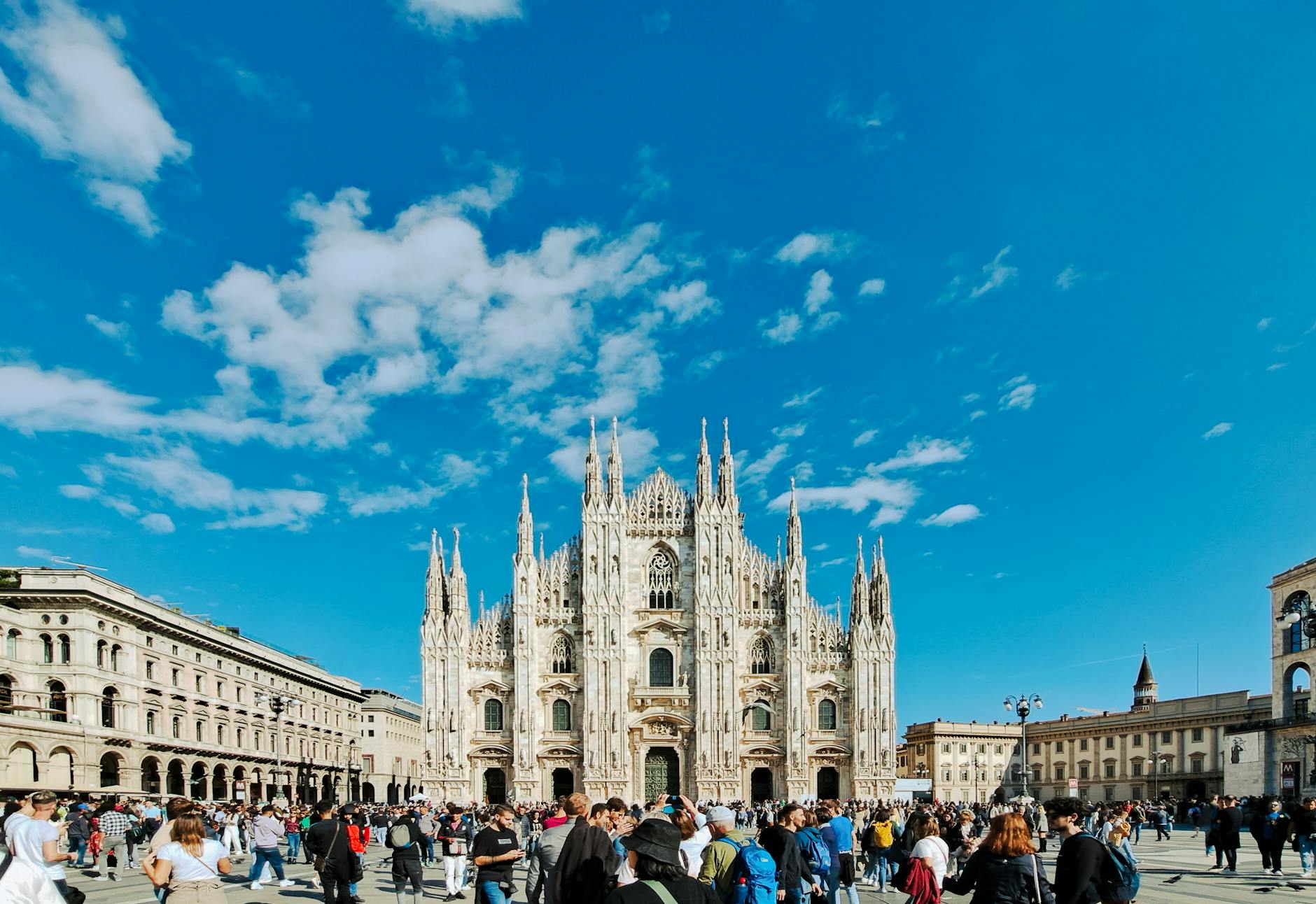Piazza del Duomo crowd during a major Milan event with banners overhead
