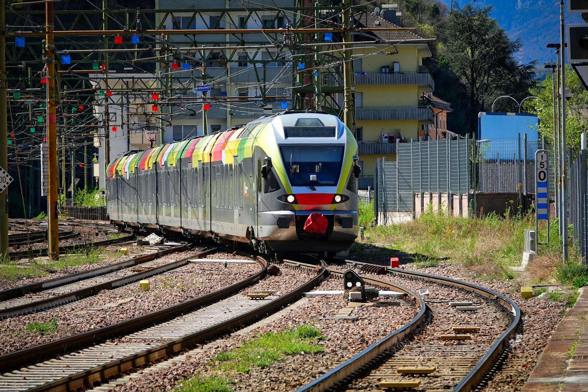 Trenord regional train at Varenna-Esino station platform with lake visible in background