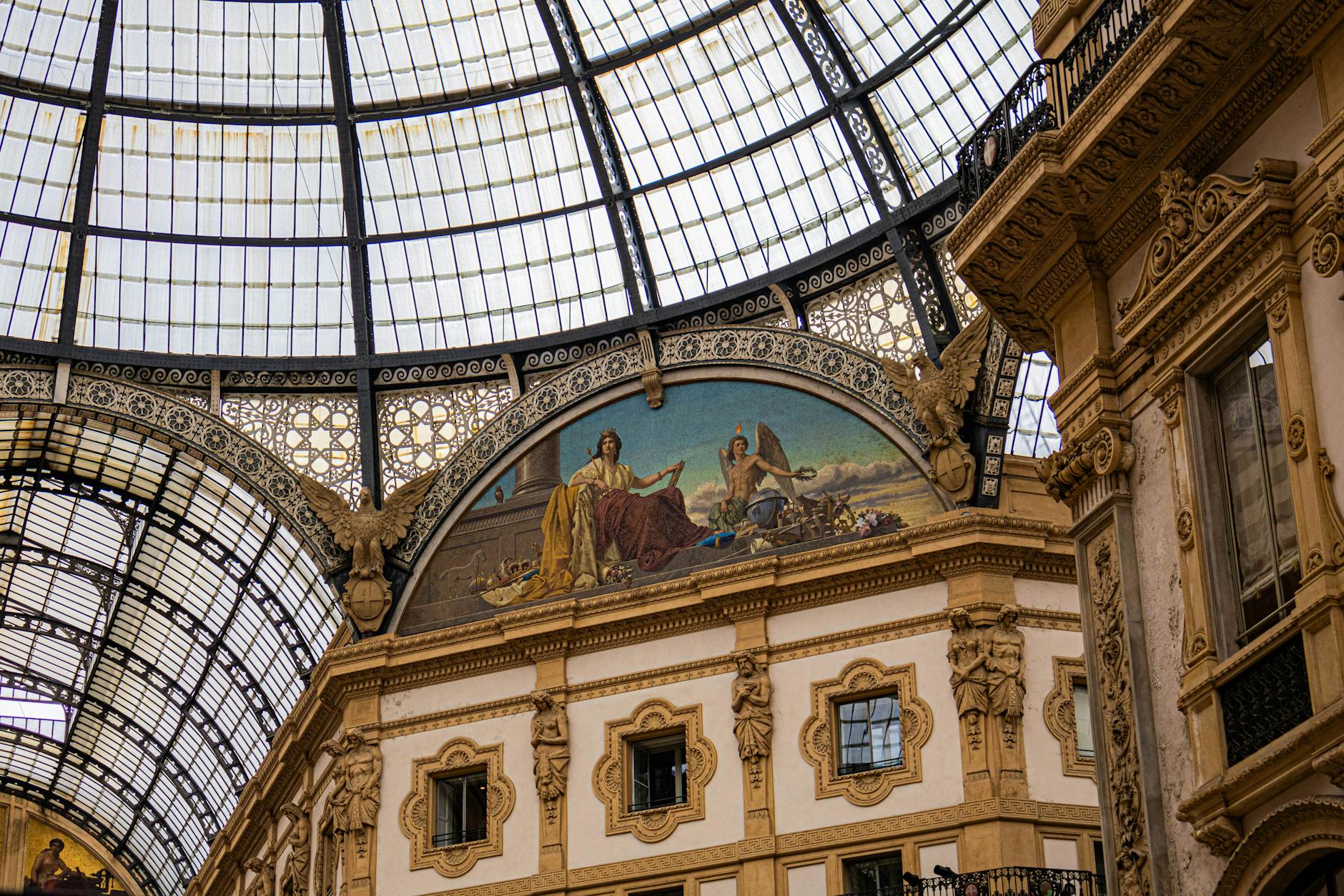 Galleria Vittorio Emanuele II glass dome from below with afternoon shoppers