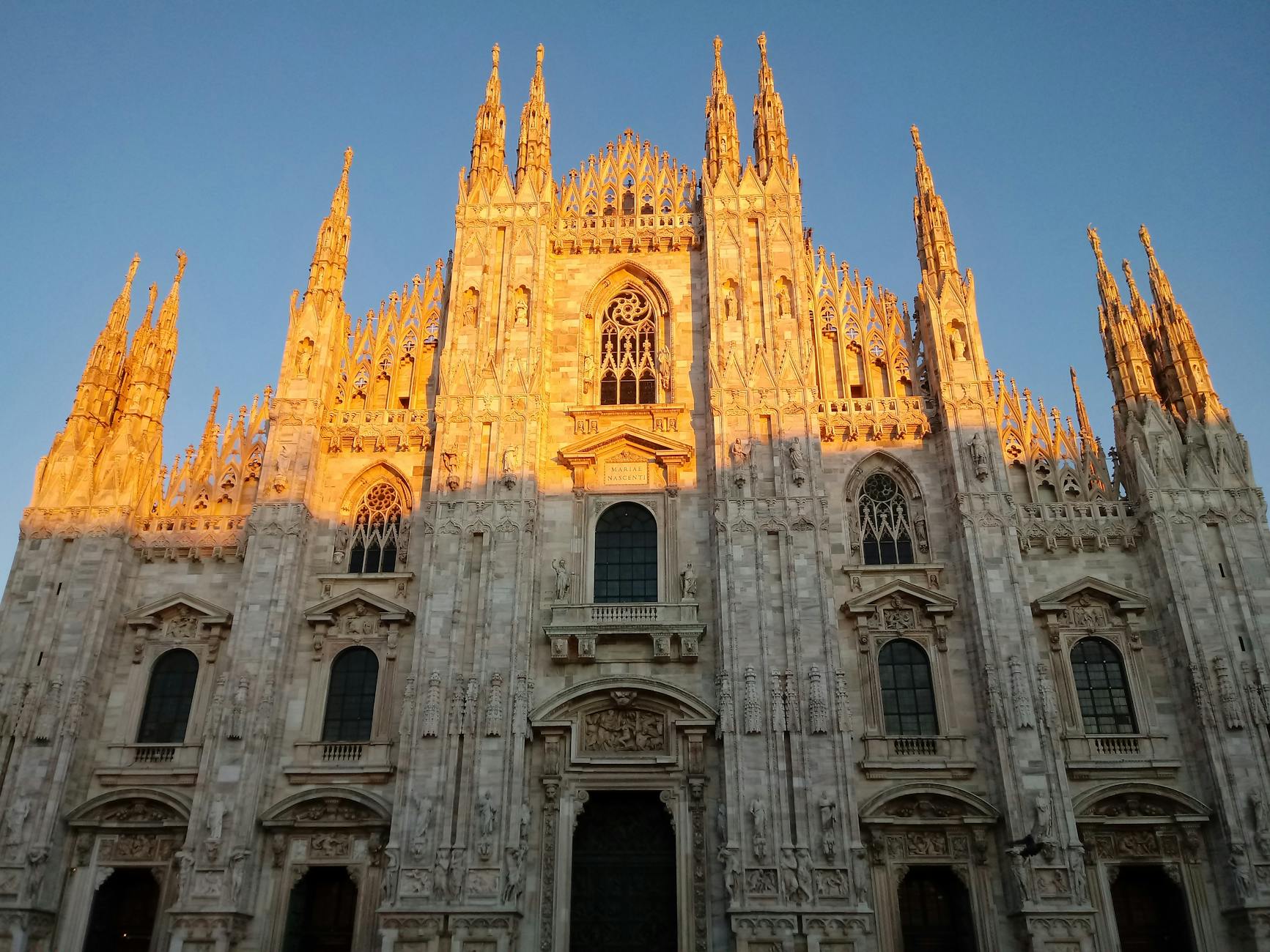 Milan Duomo at golden hour in summer with empty August piazza