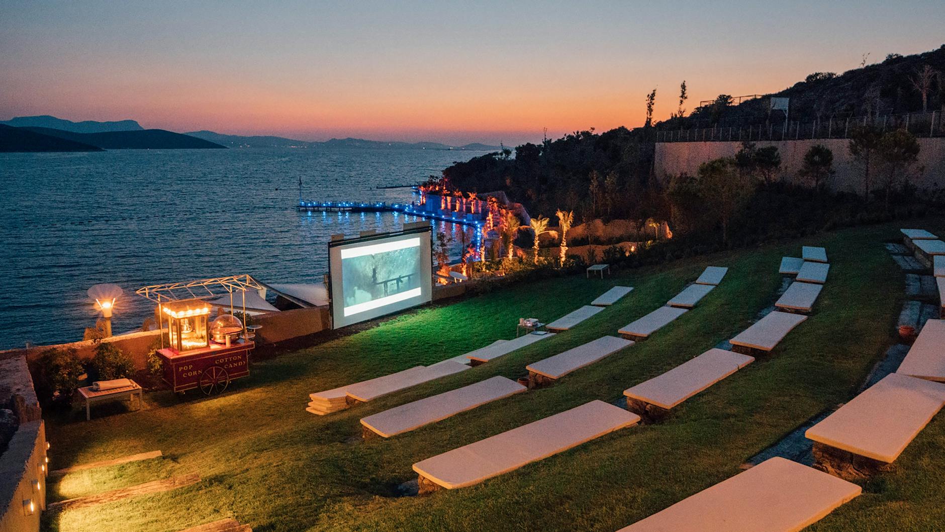 AriAnteo outdoor cinema screening at Palazzo Reale courtyard at night