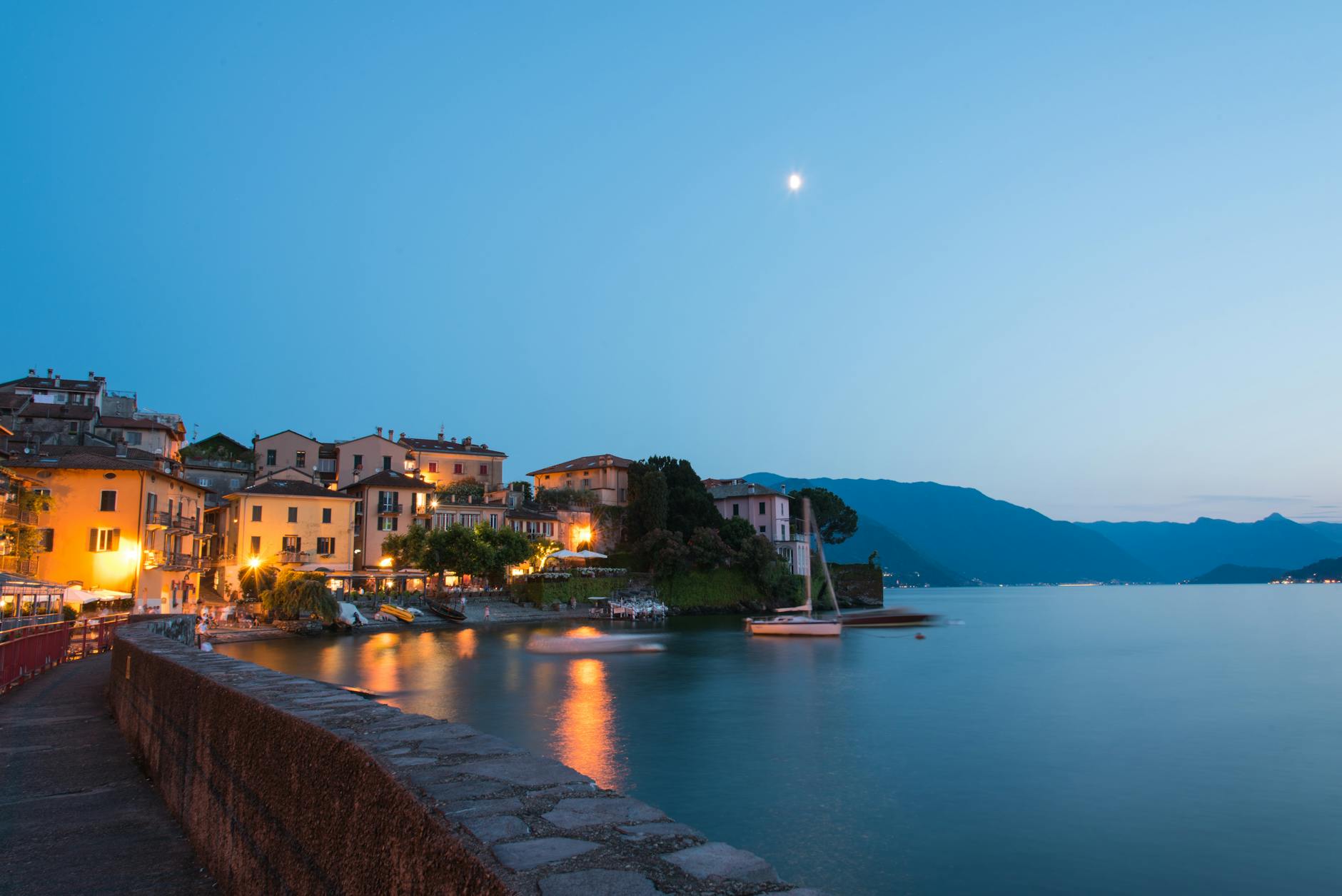 Lake Como Varenna lakefront with swimmers and ferry approaching