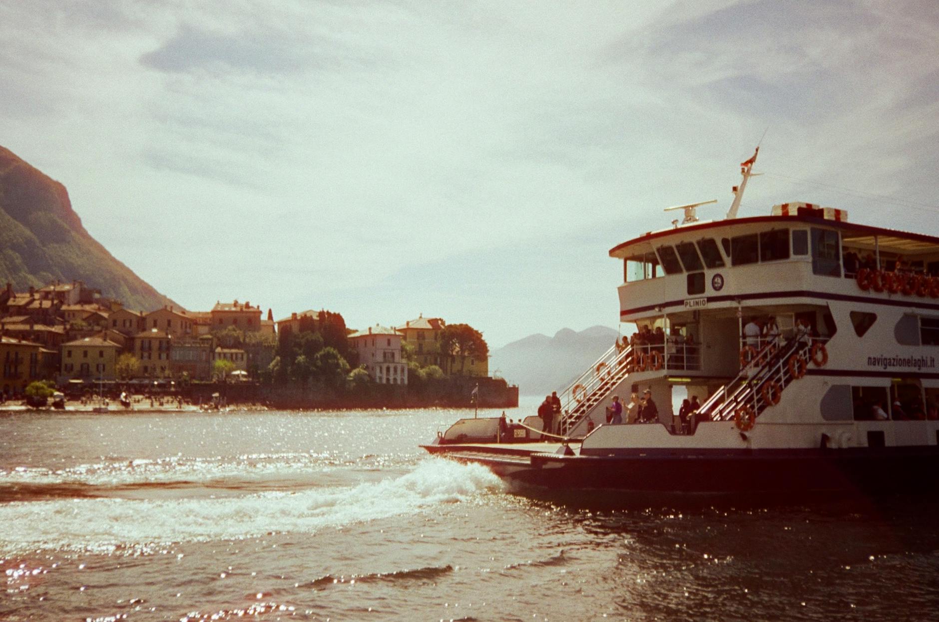 Navigazione Lago di Como ferry approaching Bellagio with pastel waterfront houses