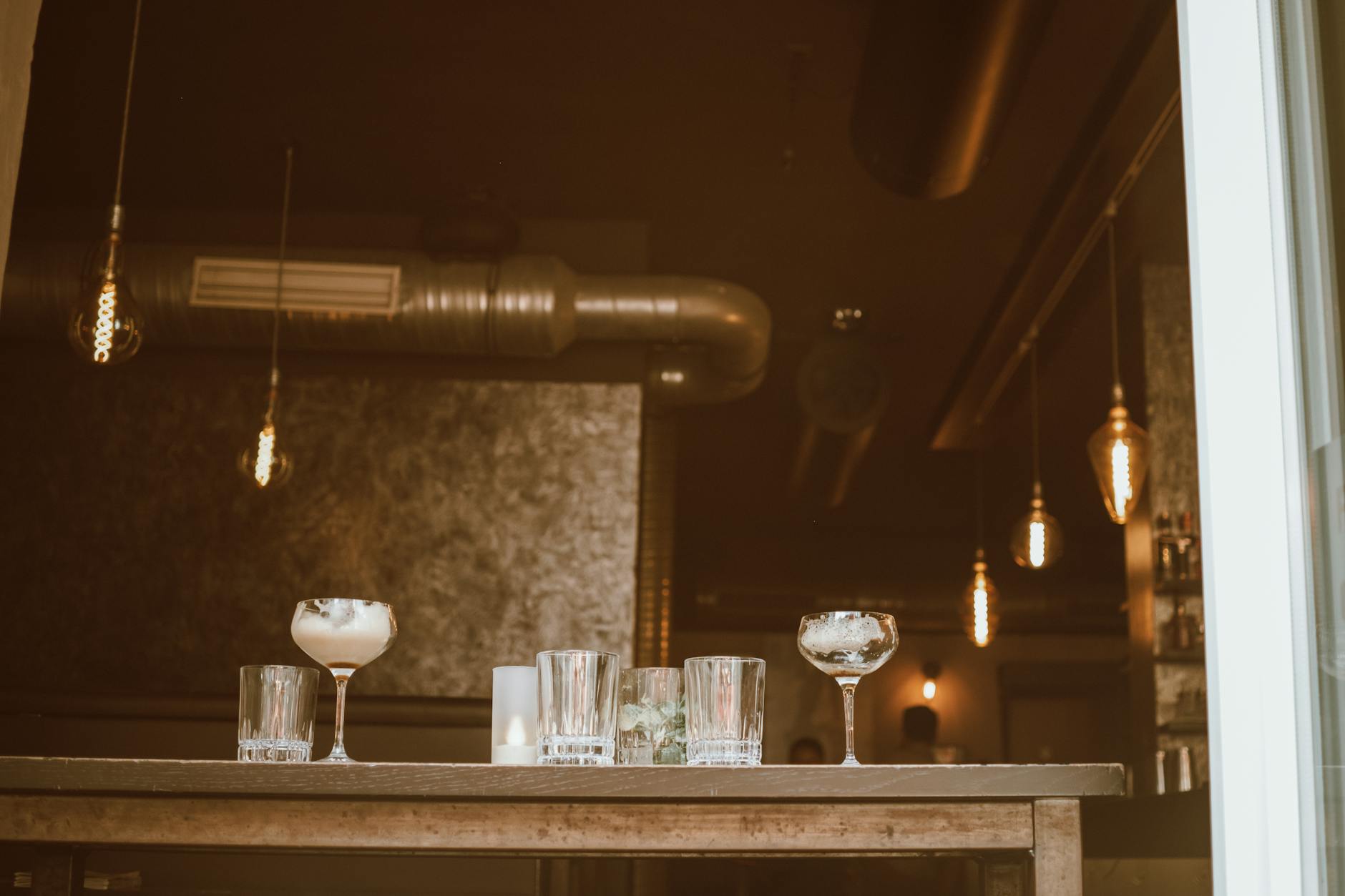 Sophisticated cocktail bar interior with moody lighting in Milan