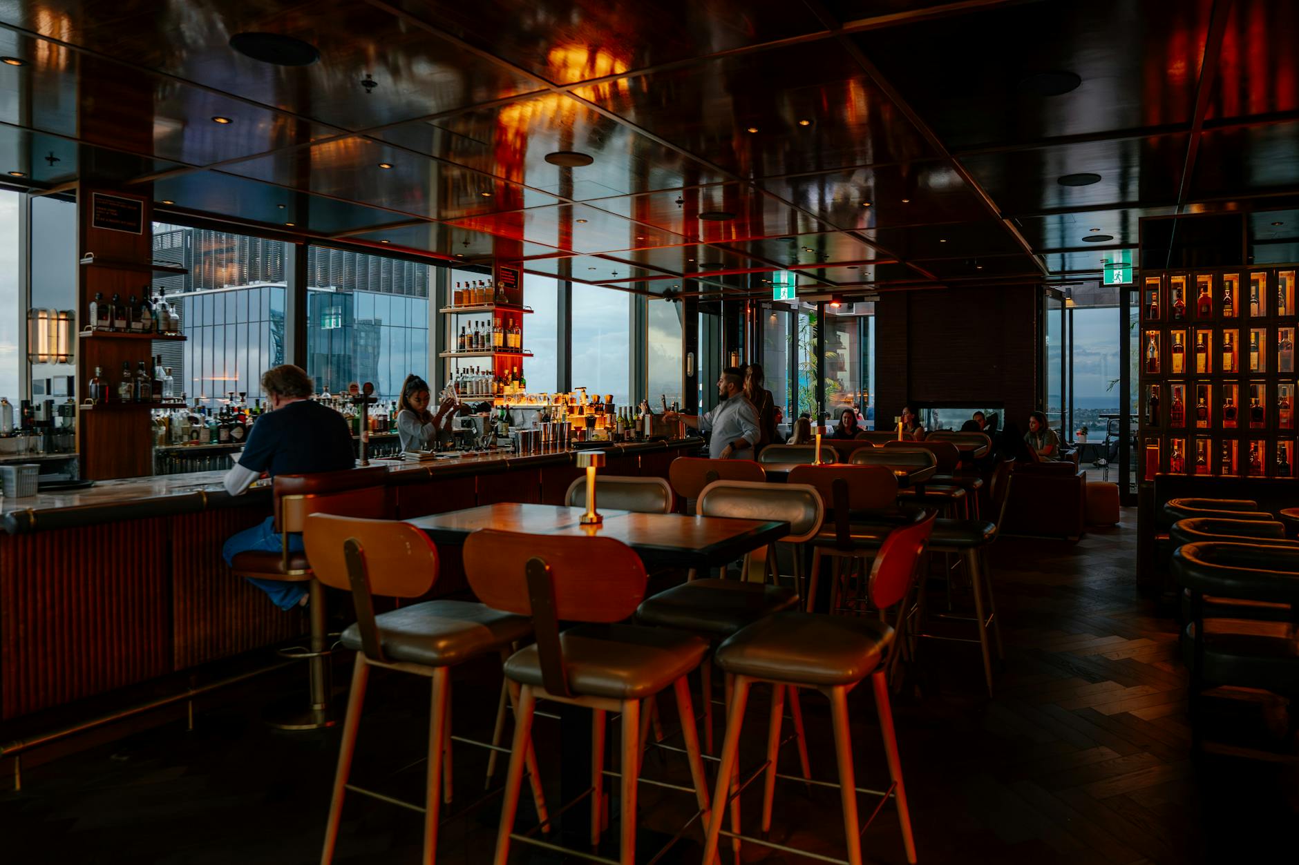 Rooftop bar overlooking Milan city skyline at evening
