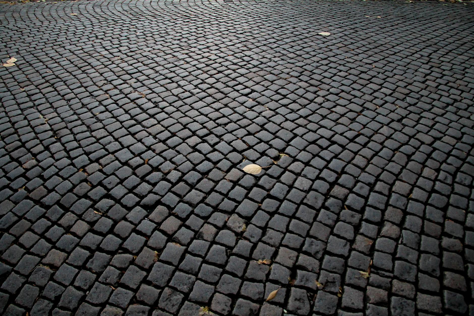 Detailed cobblestone pavement pattern in a historic European street