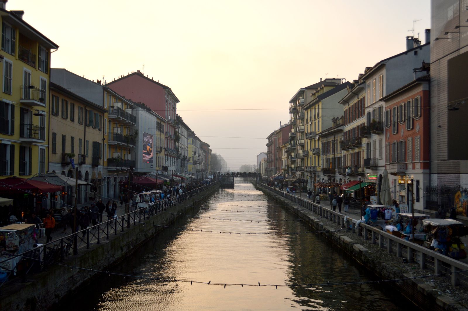 Naviglio Grande canal glowing at sunset in Milan, the start of a classic night out on the Navigli