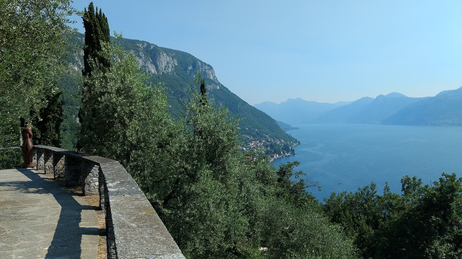 View north up Lake Como from the terrace of Castello di Vezio, with olive trees and the mountains beyond